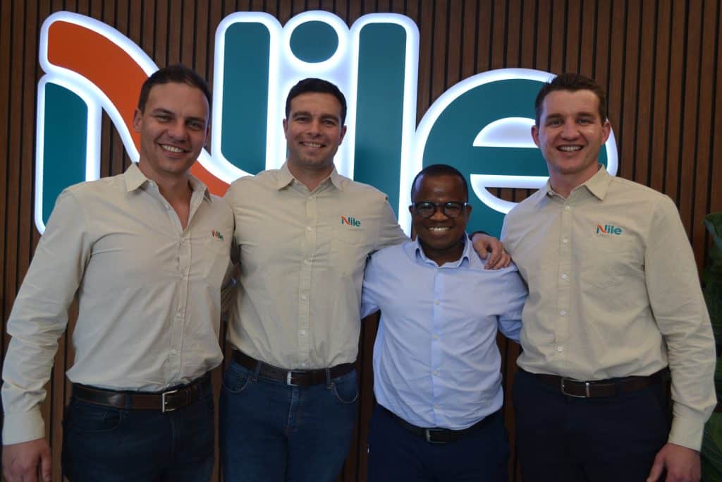 Wandile Sihlobo, chief economist of Agbiz, standing second from the right, delivered the keynote address during the launch of Nile’s new distribution hub and inputs marketplace. With him is from left to right: Michael Prinsloo head of Input Marketplace at Nile, Eugene Roodt, Nile co-founder and Louis de Kock, Nile co-founder. (Photograph: Susan Marais)