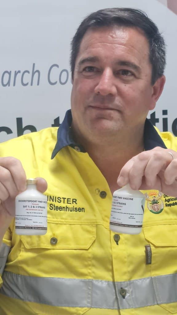 Minister of Agriculture, John Steenhuisen, with the ARC's new FMD vaccine.